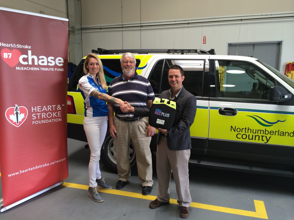 Gisele Philp, Primary Care Paramedic, Northumberland Paramedics Presents AED to member Tim Duffin, member, and Commodore Tom  Willison, 